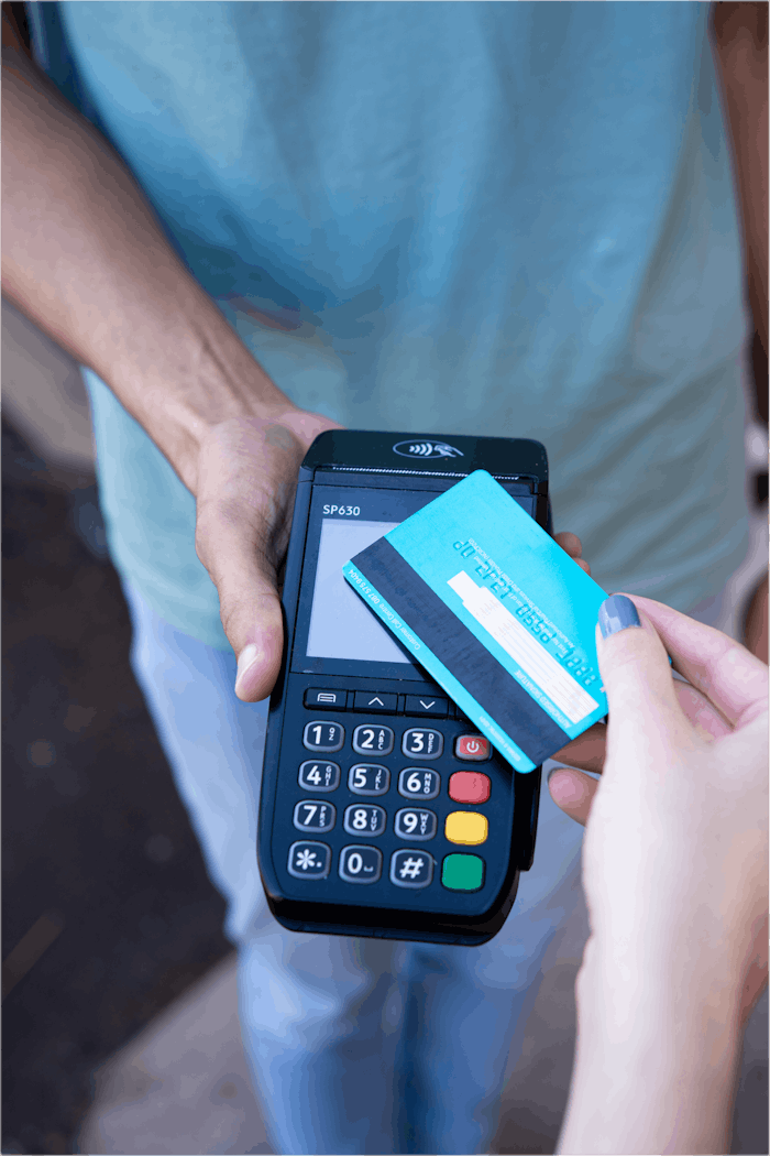 why-choose-us Close-up of hands performing contactless payment with credit card in Durban, South Africa.